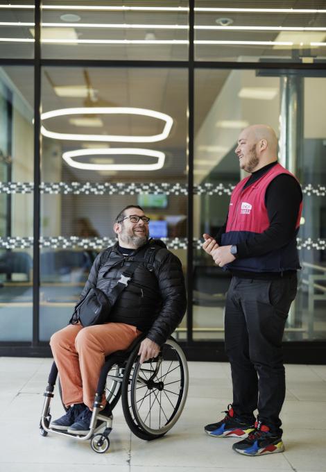 Personne en fauteuil roulant échangeant avec un agent SNCF